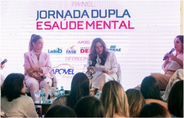 People at a concert facing the stage with various colours of paint powder in the air